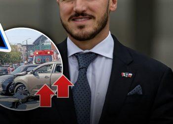 Man in a suit with flag pin; circular inset shows a car crash with ambulances and police, plus a warning sign.