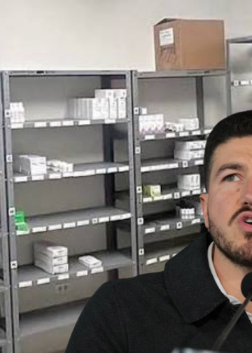 Man speaking into two microphones in a room with empty metal pharmacy shelves and scattered medicine boxes behind him